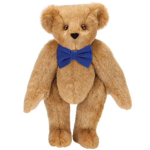 Honey-colored plush teddy bear with brown eyes and royal blue bow tie.