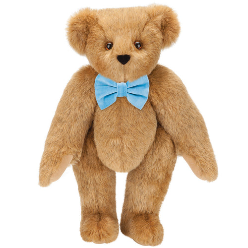 Honey-colored plush bear with brown eyes and a light blue bow tie.