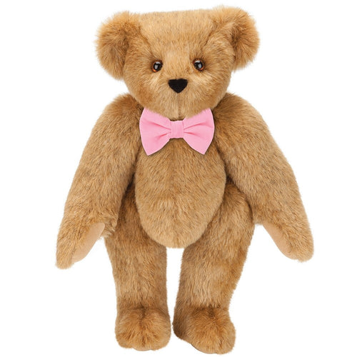 Honey-colored classic plush teddy bear with brown eyes and pink bow tie.